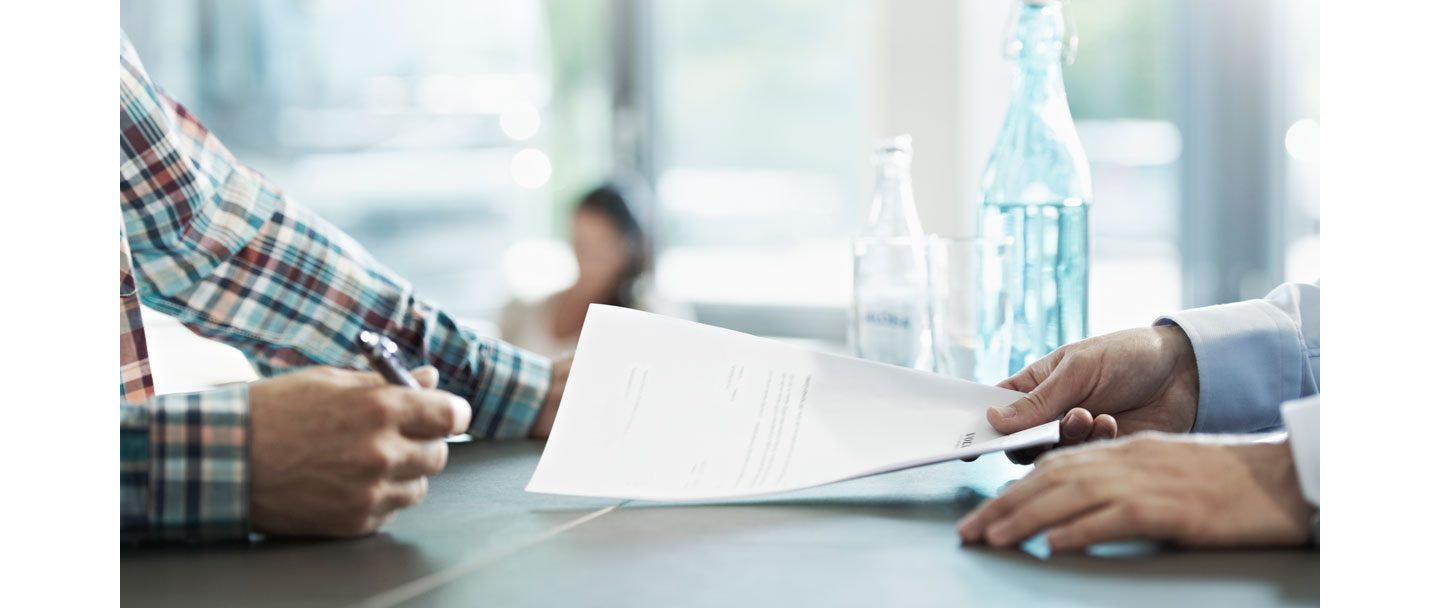 Volvo Group employee holding a document