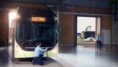 Electric Volvo bus recharging inside a bus depot