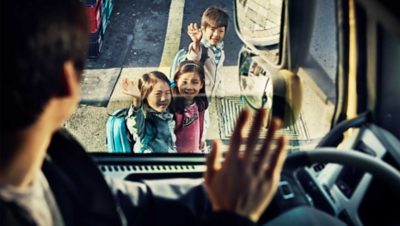 Children waving to truck driver I Volvo Group