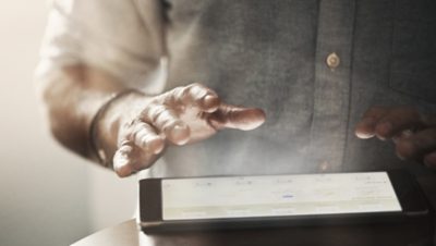 Hands holding tablet with Volvo Connect interface shown