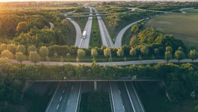 Highway with a bridge across, truck driving