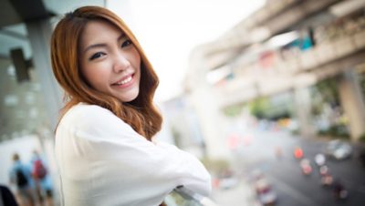 Person leaning over the railing of a balcony