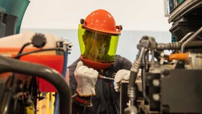 A trained technician wearing personal protective equipment