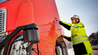 A Volvo engineer is checking a Volvo FH truck
