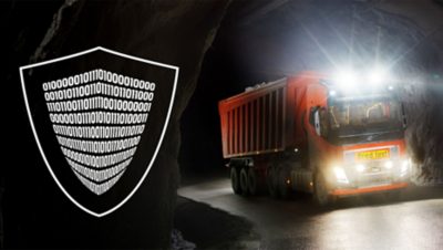Red autonomous Volvo truck driving in a tunnel