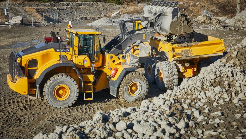 Two yellow Volvo construction machines