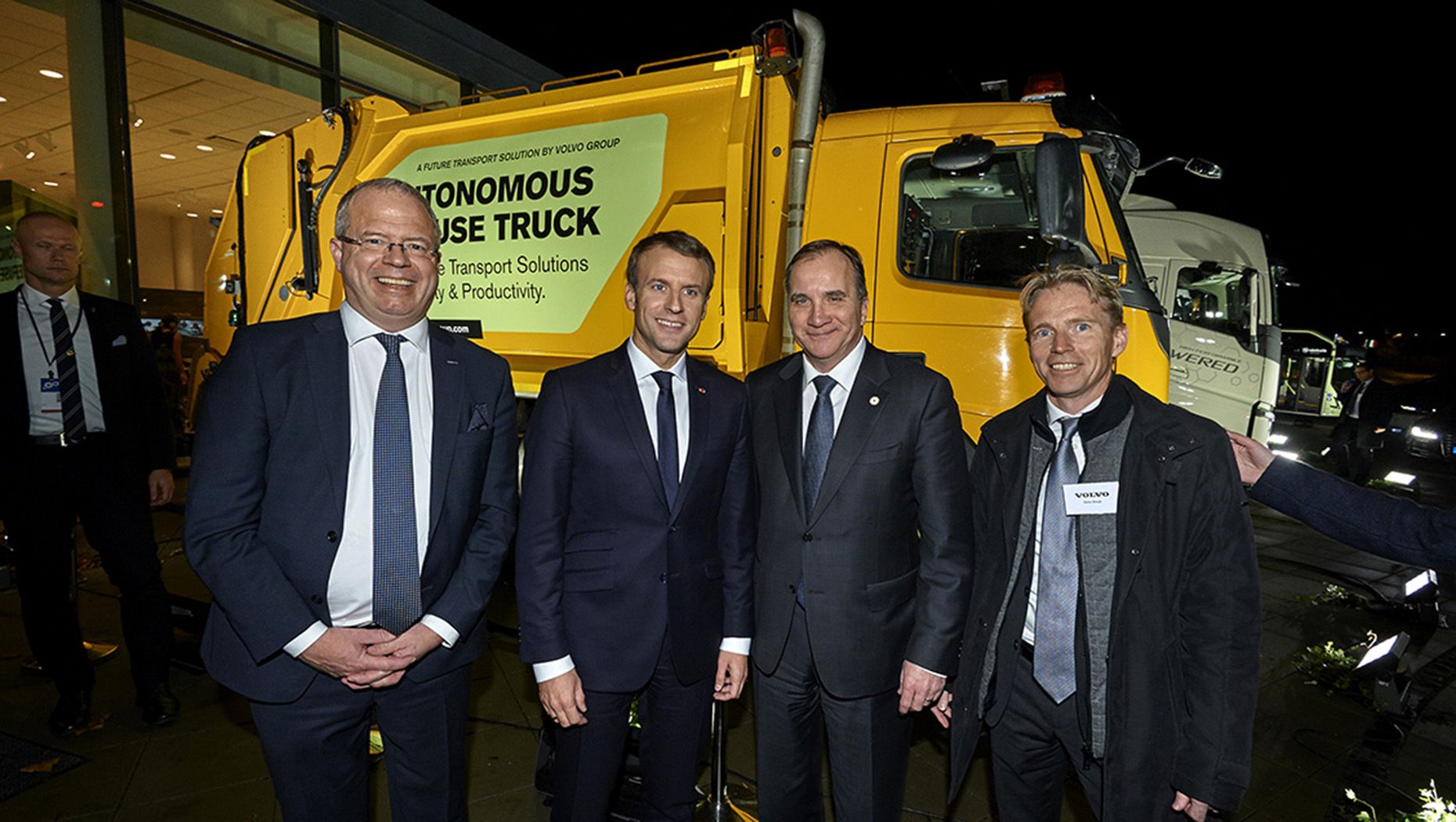 Four men in front of a Volvo refuse truck