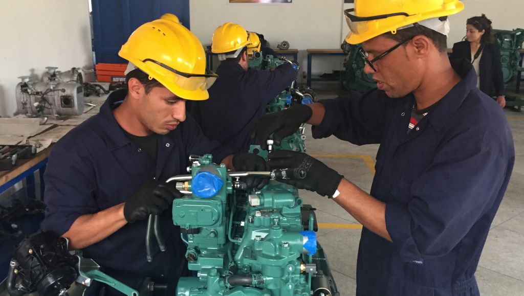 Students working with a Volvo engine