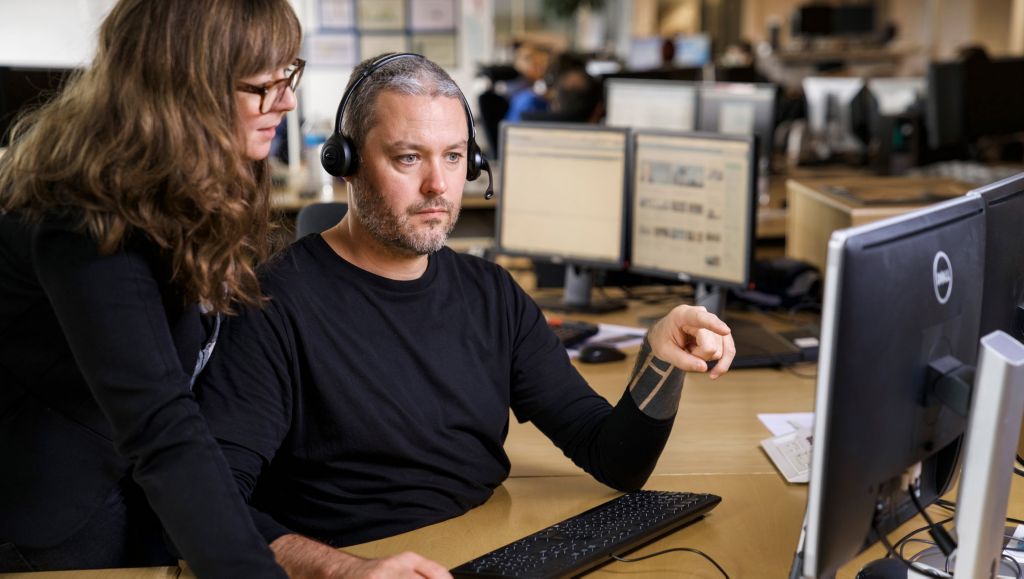 Two persons looking at a computer screen