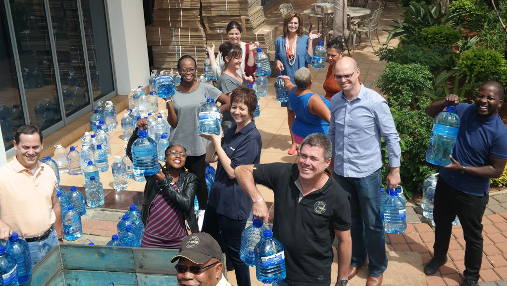 Staff from Volvo Group Southern Africa donate water and transport.