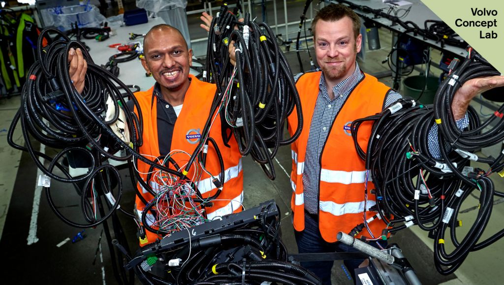 Two persons holding cables