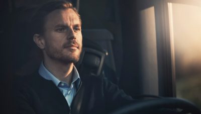 Close up of male bus driver behind the steering wheel