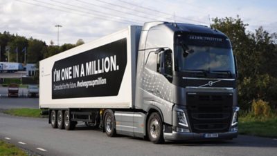 Grey Volvo truck with the message "I'm one in a million" on its payload on a road in Gothenburg, Sweden
