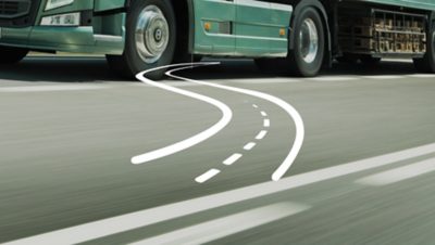 A white illustration of a serpntine road set over a green Volvo Group truck on the road