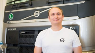 Човек стои пред Volvo FH