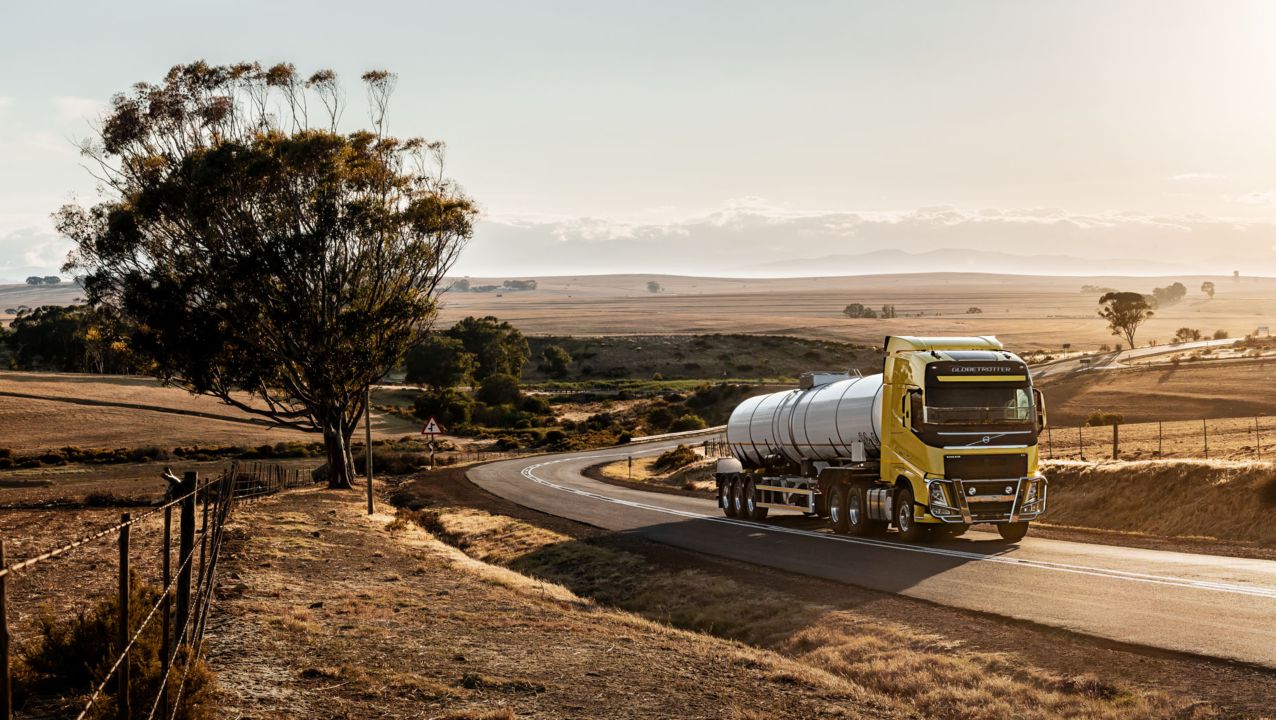 Volvo FH tanker driving uphill in rural landscape