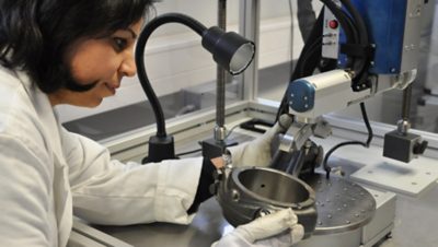 A woman observing the metallic material | Volvo Group