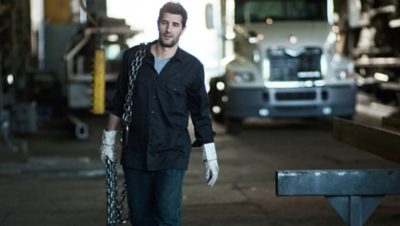 Mack Truck worker carrying a big chain over his shoulder