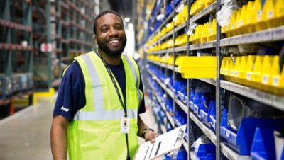 Volvo Group warehouse worker in a yellow vest