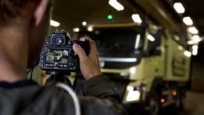 Photographer taking pictures of a Volvo Group truck
