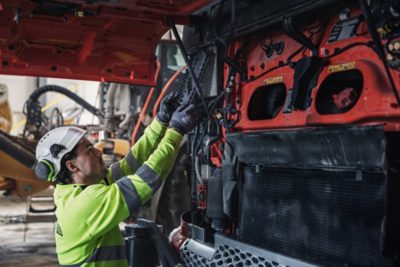 Man fixing something under the truck 