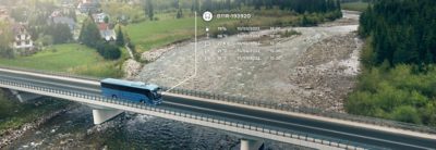 Imagen aérea de un autocar en la carretera con gráficos superpuestos.