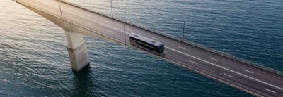 Bus driving on a bridge over water