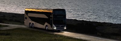 Double decker bus on a road at night