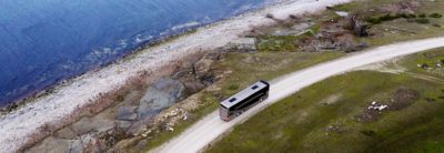 Double decker bus on a road by the sea