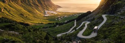 A road meandering down a valley towards the sea