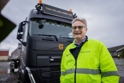 Volvo-mekaniker overleverer en pakke med Volvo-logo til en Volvo-lastebilsjåfør