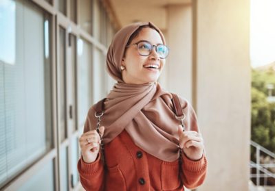 University, education student and muslim woman in campus ready for learning, studying or knowledge. College, scholarship development or Islamic female thinking or contemplating vision for future life.