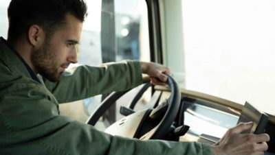 A driver checks his digital side display 