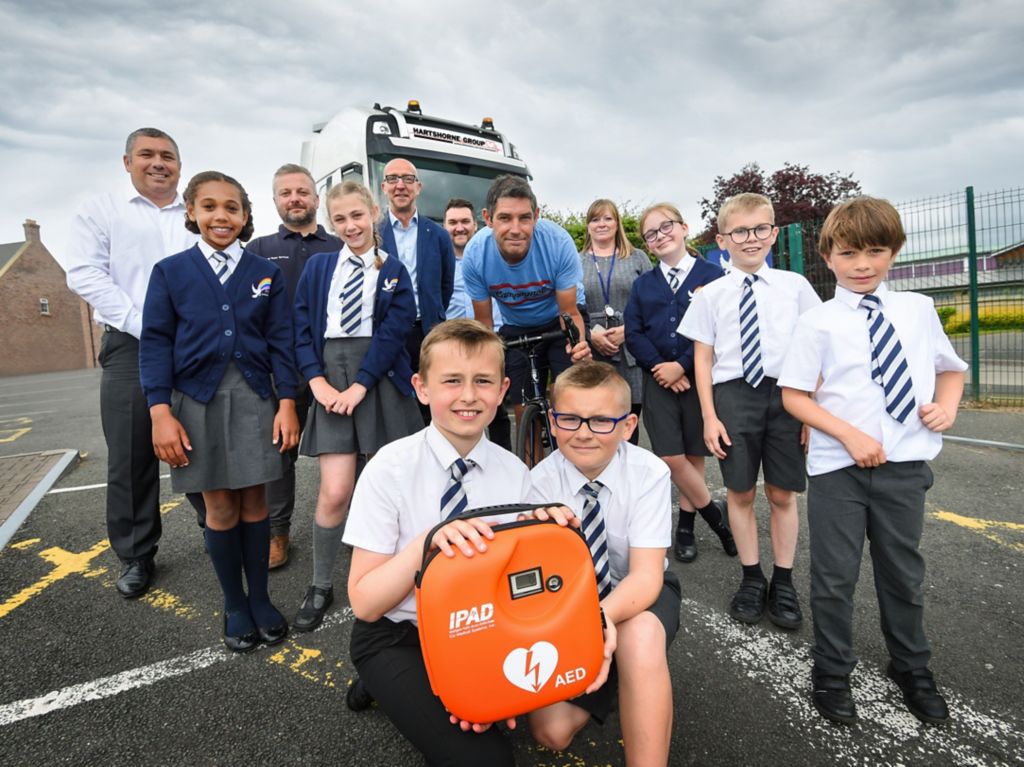 School receives life-saving heart device after proud dad cycles over 1,600 miles!
