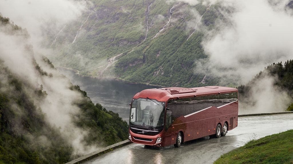 A Volvo 9900 on a scenic road