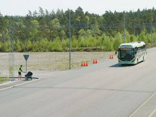 Volvo bus on road, pedestrian crossing