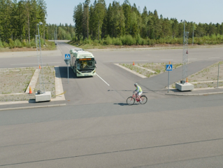 Volvo bus on road, bicycle crossing
