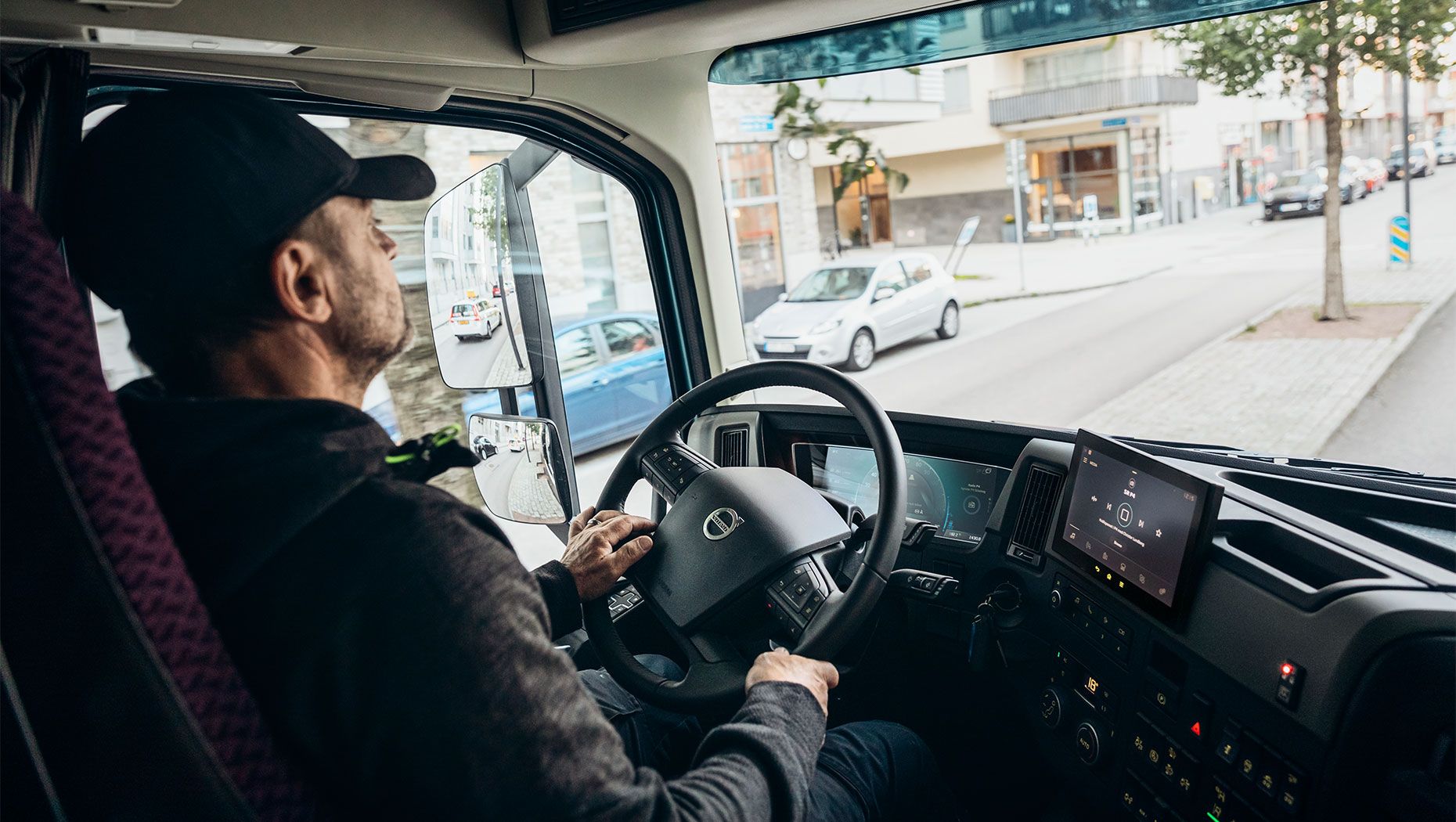 Driver driving in inner city with traffic around him