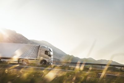 Volvo FH16 Aero mirrored in water, viewed from the side