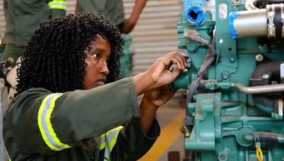 A student in Zambia works on an engine