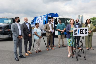 Volvo Group Vice President of Government Relations and Public Affairs,  Dawn Fenton, delivers remarks alongside New York State Assemblywoman Amanda  Septimo (far right) and New York City Council Member Rafael Salamanca Jr. (right),  along with representatives from NYSERDA, NYCEDC and MN8 Energy. They gathered  for the unveiling of a freight-focused electric charging hub and the delivery of a Mack  LR electric refuse vehicle, the first of nine electric vehicles from Volvo Group, as part of  “The Bronx is Breathing: Reimagining a Cleaner Hunts Point” project.