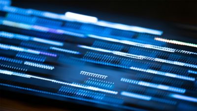 Close-up of digital data and illuminated patterns, representing the data-driven tools and collaboration supporting Volvo Buses’ decarbonization journey.