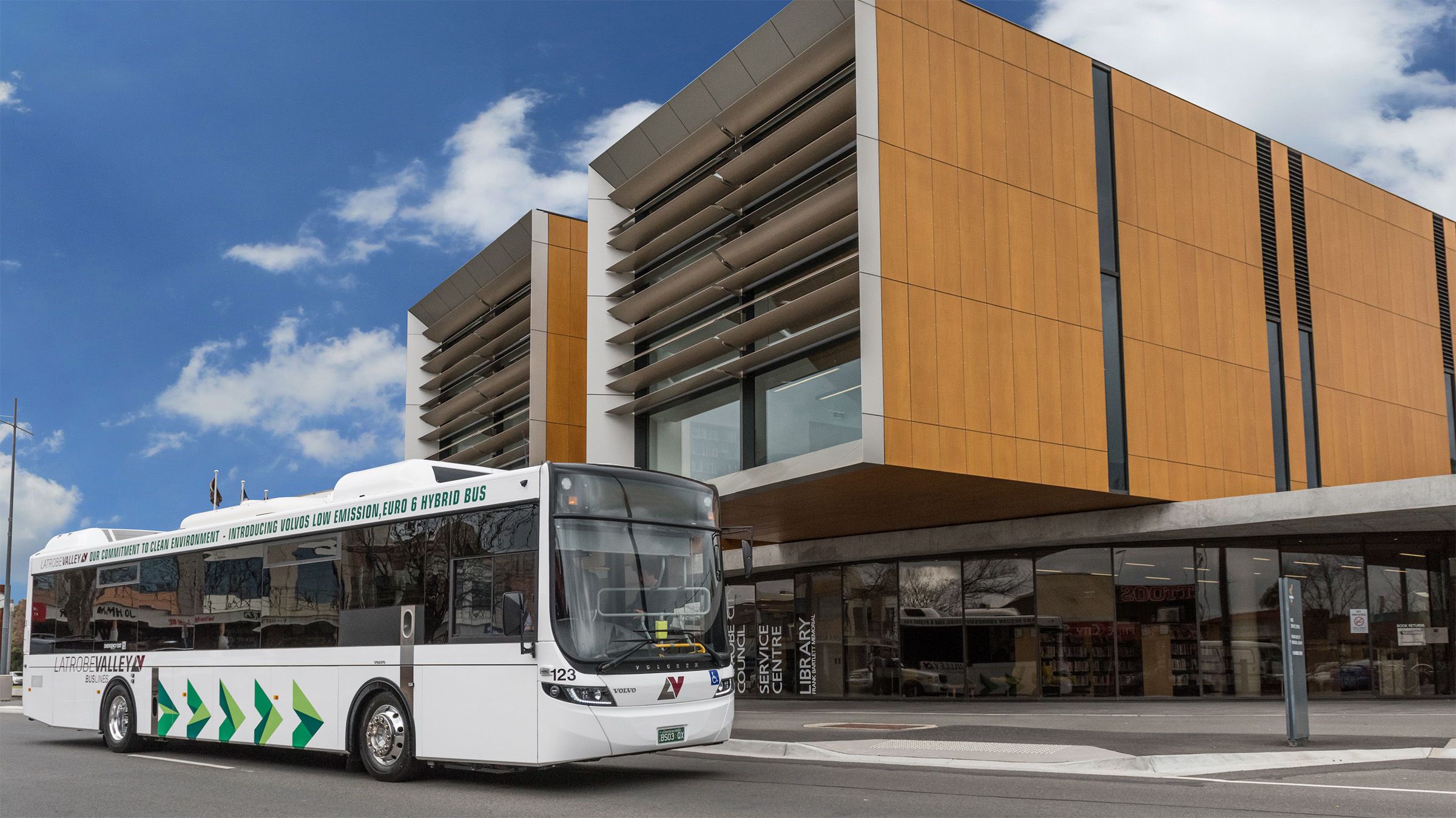 A Volvo B5L S-Charge in front of building