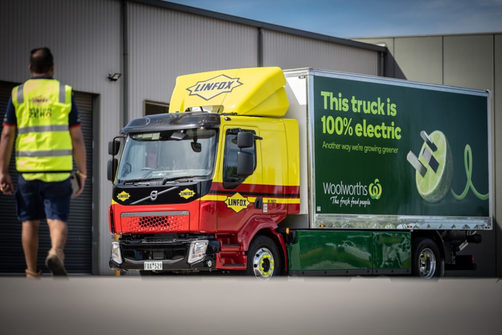 A man walking towards the Volvo FL electric truck