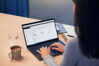 Female working with computer with Volvo Connect on screen