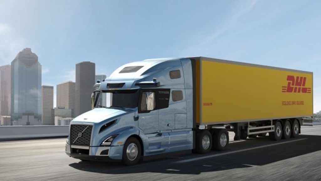 Volvo VNL Autonomous truck with DHL trailer driving on a highway