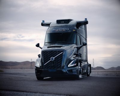 Parked volvo autonomous truck on the side of the road under an overcast moody sky
