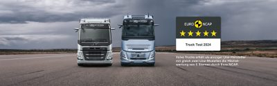 Radfahrer fährt in der Stadt an einem Volvo FM vorbei