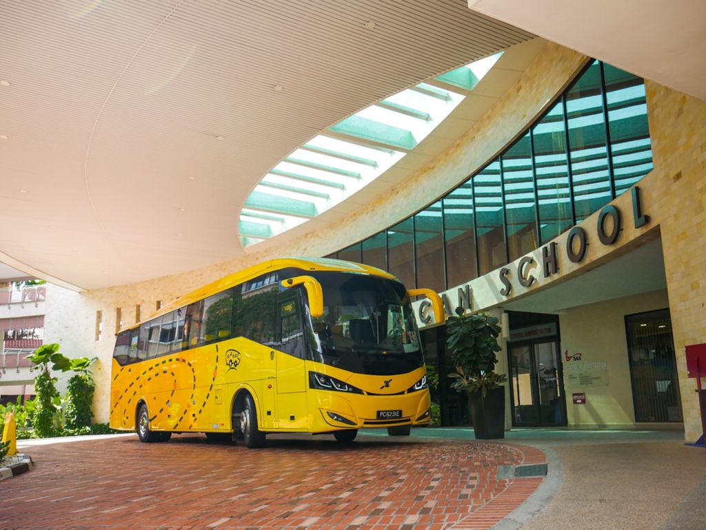 Volvo B7R coach parked outside a school in Singapore