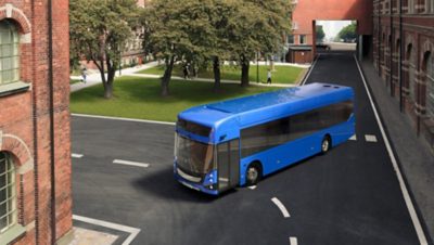 A blue Volvo BZL Electric single-decker drives through a campus area 